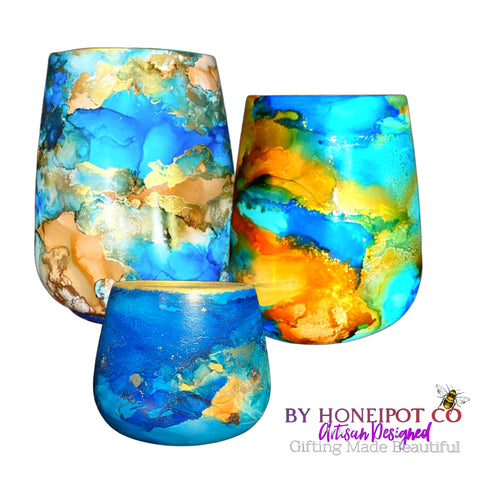 trio of small, medium ans large plant pots in stunning Caribbean inspired blues and earth reminiscent hues, accented by glistens of pearl and gold 